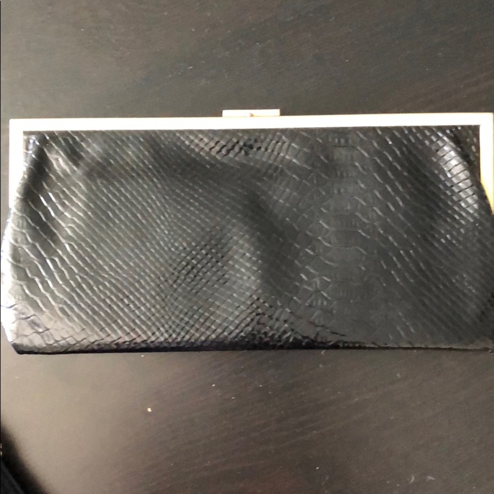 Black sleek clutch with gold accents.